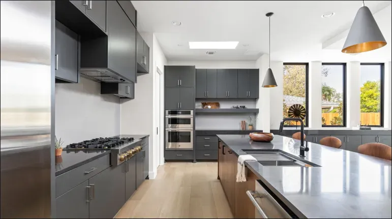 High-End Kitchen Transformation: JennAir appliances in a sleek, modern, dark gray cabinet design.